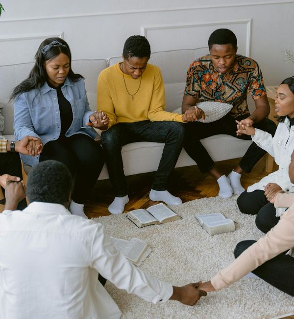 Diverse group of people of various ages sitting peacefully in a circle.